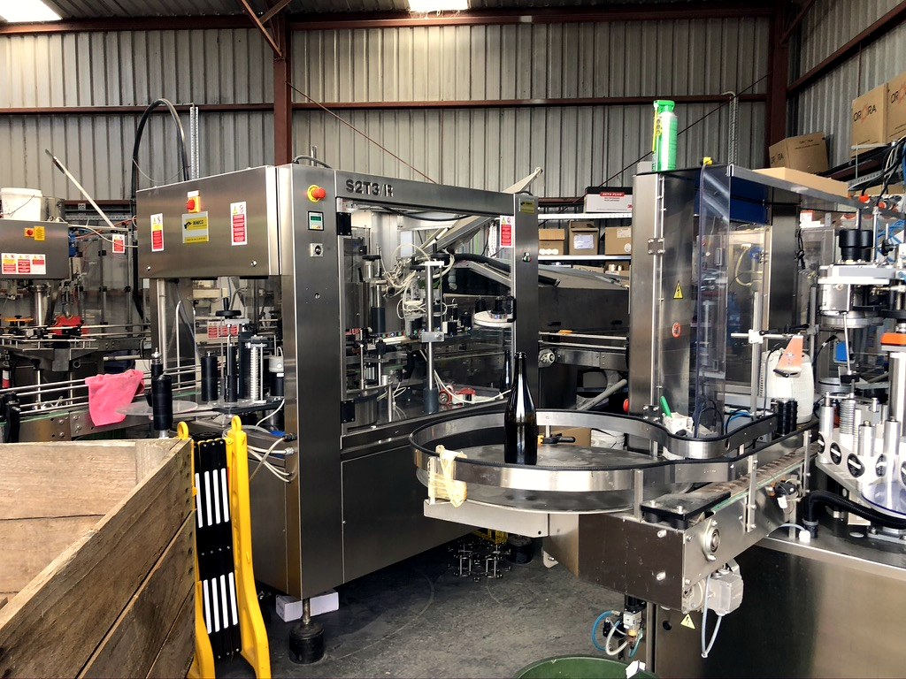 Bottling and labelling equipment inside the production facility.